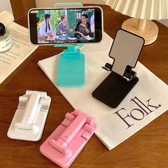 携帯型携帯電話のタブレットスタンドは生放送で劇の写真を見ます。
