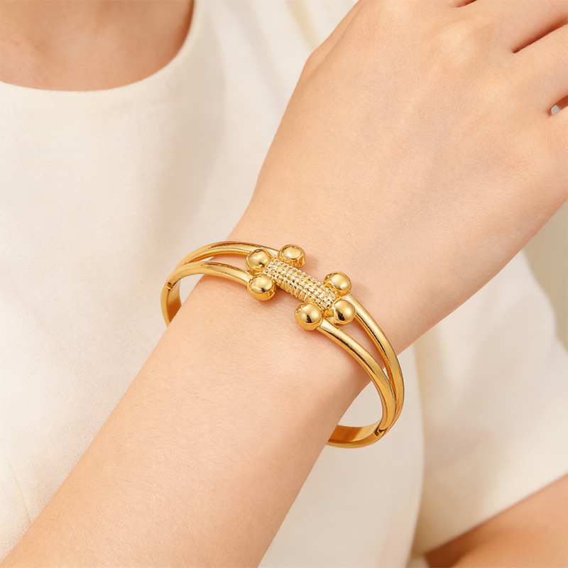 Brazalete de acero inoxidable de moda transfronteriza europea y americana lujo ligero de alto nivel sensación de bolas pequeñas h brazalete de apertura de oro mujer al por mayor