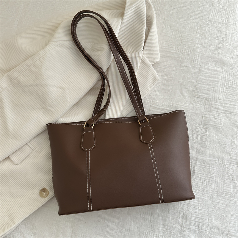 Bolso de viaje de alta gama retro 2025 primavera nuevo estilo salvaje ins color sólido bolso de hombro de trabajo bolso Tote