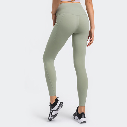 One piece drop shipping new upgraded nude yoga pants high waist abdominal side pocket sports running fitness nine-point pants