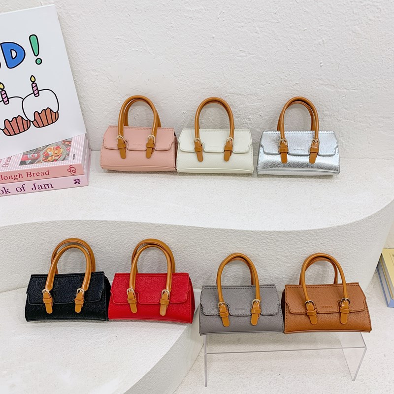 2025 nuevo bolso para niños de comercio exterior, bolso de niña popular de moda coreana, bolso de mensajero para bebé de color sólido de estilo extranjero