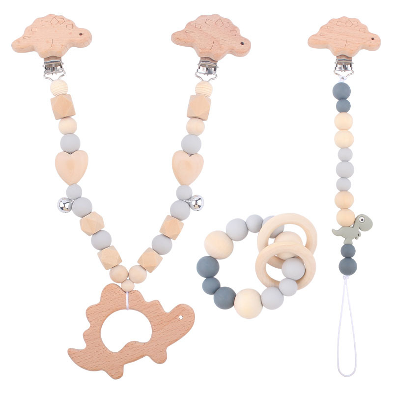 Suministros para bebés pulsera de silicona molar de juguete para niños Cadena de cochecito de dinosaurio de tres piezas creativa pequeña campana colgante