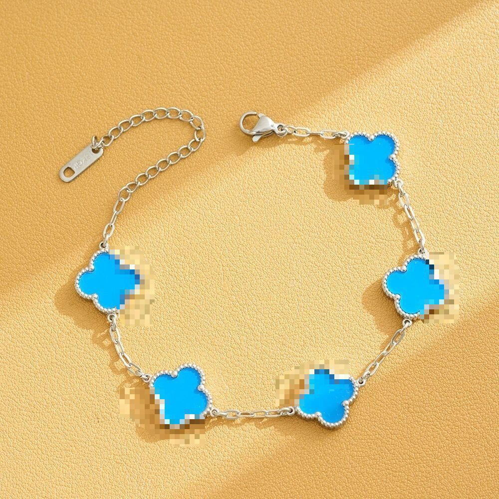 Pulsera de trébol de acero titanium vendedora caliente transfronteriza europea y americana con incrustaciones de concha pulsera colgante pulsera de diseño avanzado sin desvanecimiento al por mayor