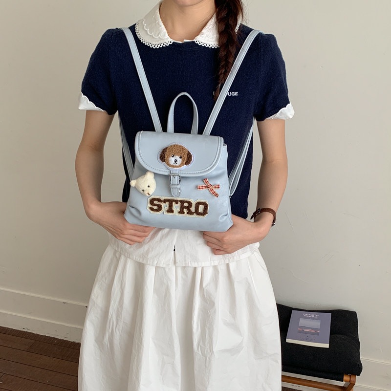 Tide retro nuevo 2026 cachorro nicho de dibujos animados femeninos, mochila coreana, mochila encantadora de moda para viajar