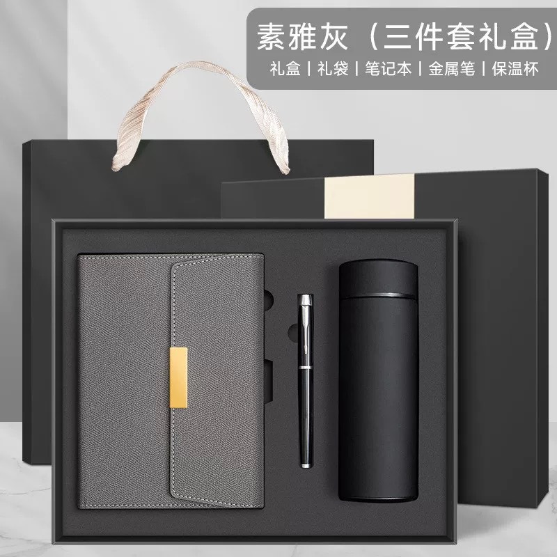 Elegante caja de regalo gris, bolígrafo de metal y termo