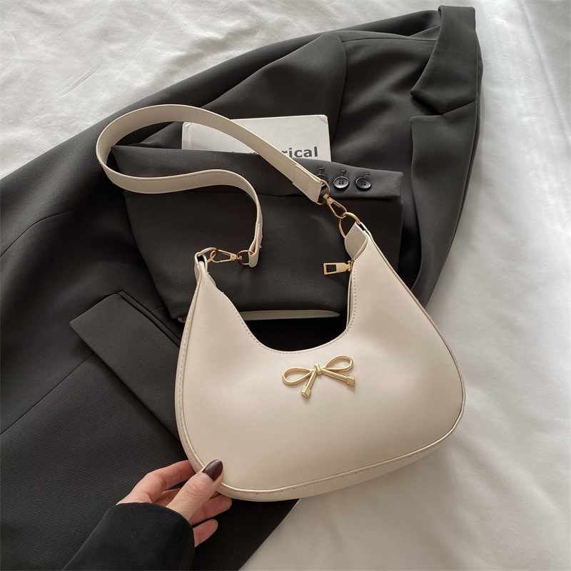 Sensación de la axila bolso pequeño mujer 2025 primavera nueva moda todo-fósforo bolso de hombro diseño de nicho bolso de palo francés mujer