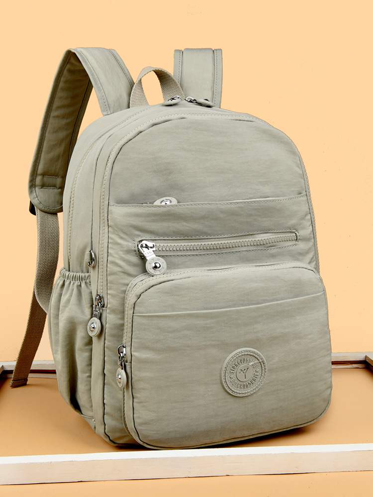 Mochila de hombro de comercio exterior 2025, nueva mochila de computadora simple de color sólido, mochila de escuela secundaria, mochila para hombres y mujeres.