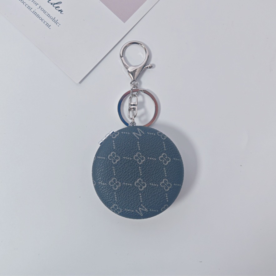 Bolsa de espejo popular en línea colgante de lujo ligero llavero portátil espejo de maquillaje transfronterizo colgante de bolsas de espejo doble cara