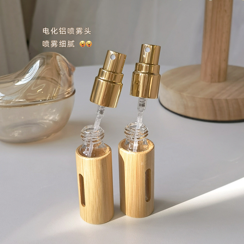 En stock al por mayor 5ml10ml botella de spray de bambú forro de vidrio boquilla electroquímica de aluminio perfume embalaje de embalaje botella vacía
