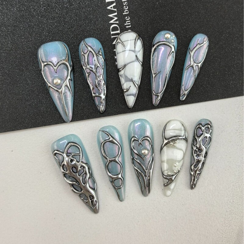 European and American hot girls' Y2K metallic style press-on nails in ice blue aurora, long pointed nails with dark heart designs, heavy-duty detachable nail pieces