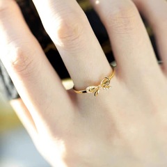 Gold-plated brass simple and fashionable open-mouthed ring with butterfly knot for women, a piece of jewelry from the Yunnan Sand Gold Series.
