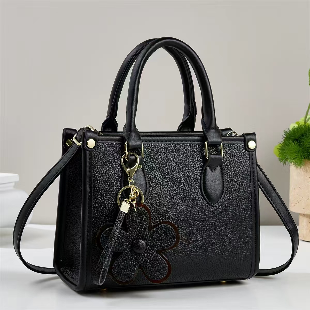 Temperamento exquisito bolso de mano mujer 2025 otoño moda versátil bolso de hombro flor decoración inclinada bolso de mano transfronterizo