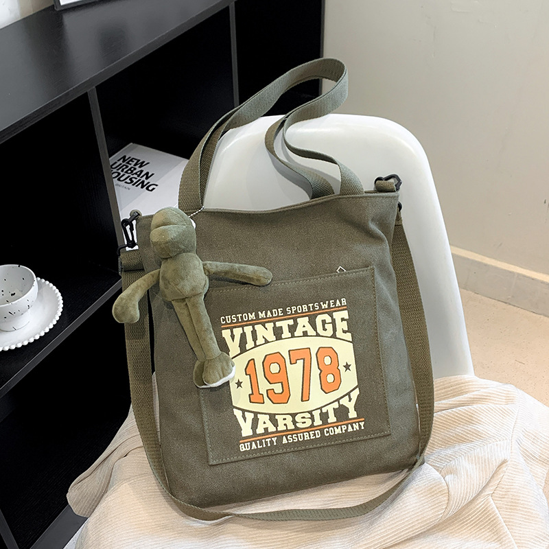 Comercio exterior engrosada bolsa de lona para hombres y mujeres misma gran capacidad estudiante retro bolso de escuela bolsa de hombro bolsa de mensajero