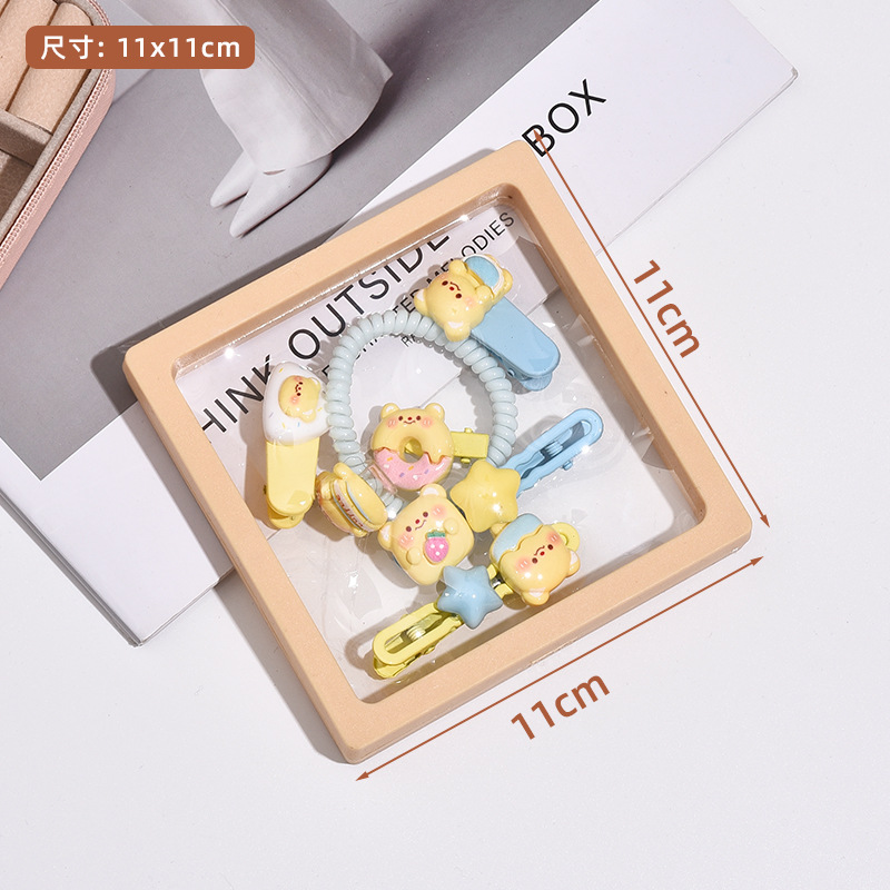 Linda combinación de accesorios para el cabello de la serie de osito amarillo lechoso dulce clip de flequillo de cabello roto de alta elasticidad lazo para el cabello al por mayor