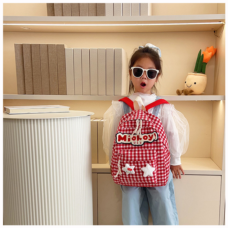 The large-capacity red woolen checkered backpack for primary and secondary school students is a unique and versatile choice. It's a trend for girls to carry backpacks during their leisure trips undefined