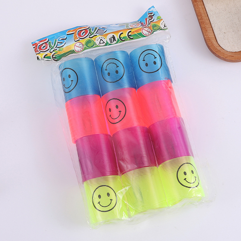 Nuevo 3.2 * 3.5cm sonriente transparente pequeño arco iris bobina de plástico para niños juguetes plegables