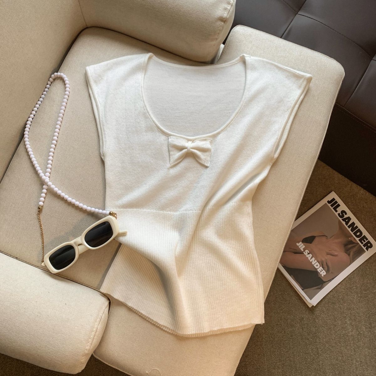 Silk knitted sweater with bow with a round collar