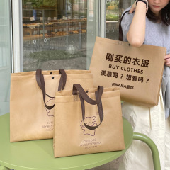 肩のバックルの不織布の手提げ袋の環境保護の服の店は服を詰めて買い物の贈り物の卸売りを包装することができます。