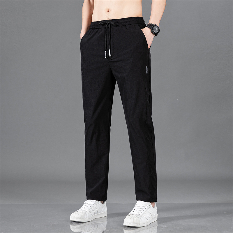 Pantalones largos delgados de verano para hombres tendencia universal de hielo rápido secado deportivo relajado grande pantalones casuales al por mayor