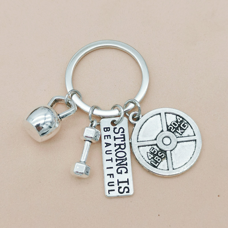 Nueva joyería europea y americana deportes poder mancuerna barra hervidor campana llavero hombres y mujeres pareja amistad llavero