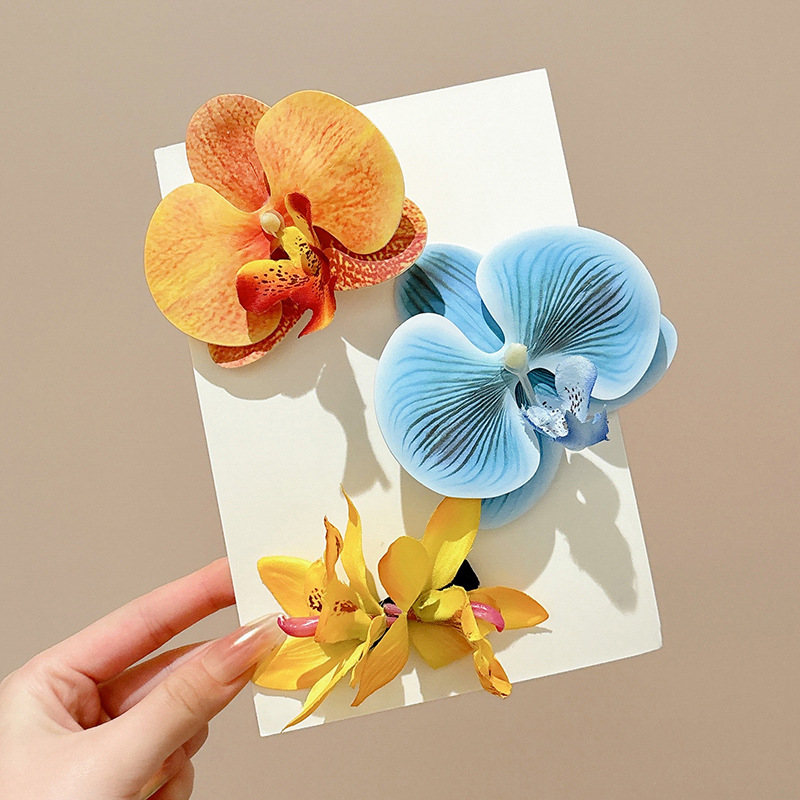 Atmosfera orquídea mariposa flores clip para el cabello mujeres primavera / verano 2025 nuevo clip lateral tocado tarjeta de cabello vacaciones de mar