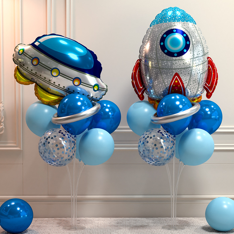 Children's little boy's 10th birthday party decoration scene layout astronaut rocket balloon table floating on the ground