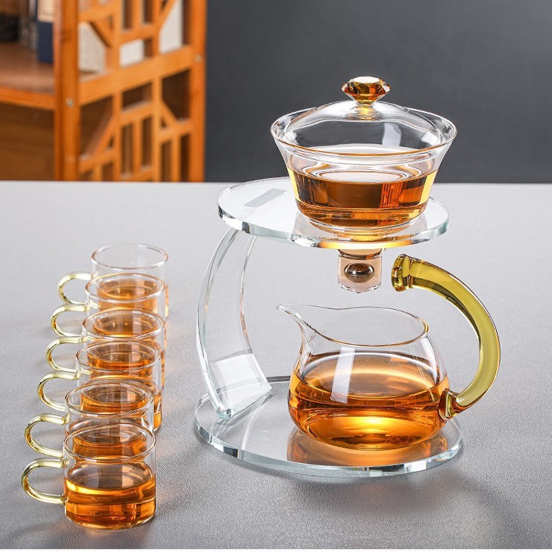 Fábrica al por mayor de vidrio resistente al calor taza de té perezoso traje hogar Kung Fu juego de té engrosada tetera de succión magnética Fabricación de té automática