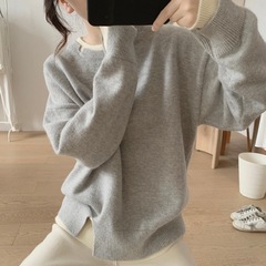 丸首のニットのコートの女性の秋冬の新型はゆったりしていて、やせています。