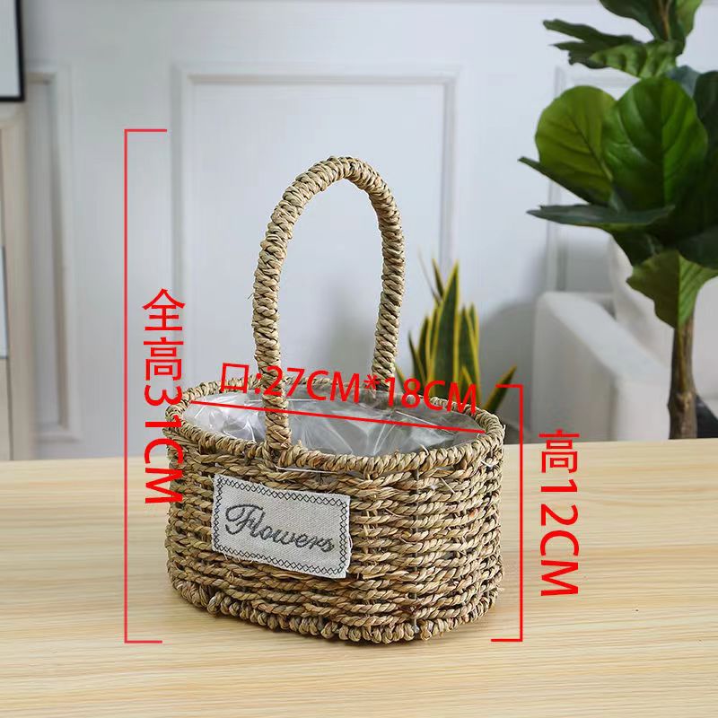 Fabricantes de cestas de flores ovales rectas de paja hechas a mano en stock al por mayor cestas de flores de paja portátiles decoración de viento pastoral