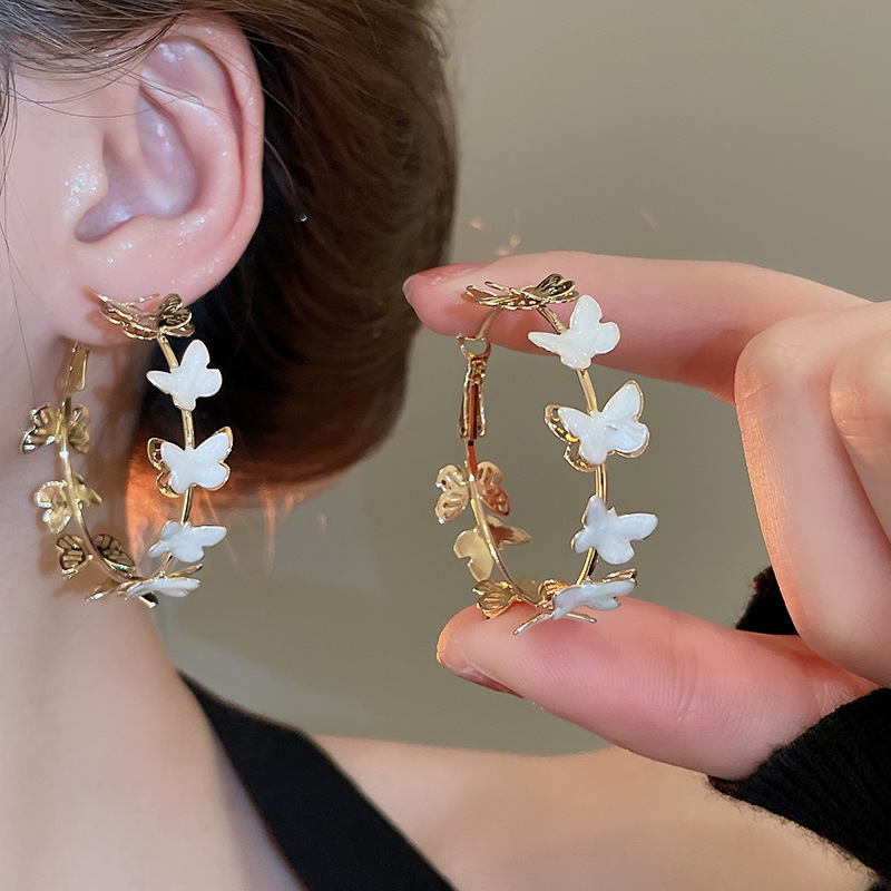 Pendientes de flor de lazo elegante de súper hada de plata Pendientes de moda de lujo ligero francés Pendientes de todo fósforo dulce de estilo literario