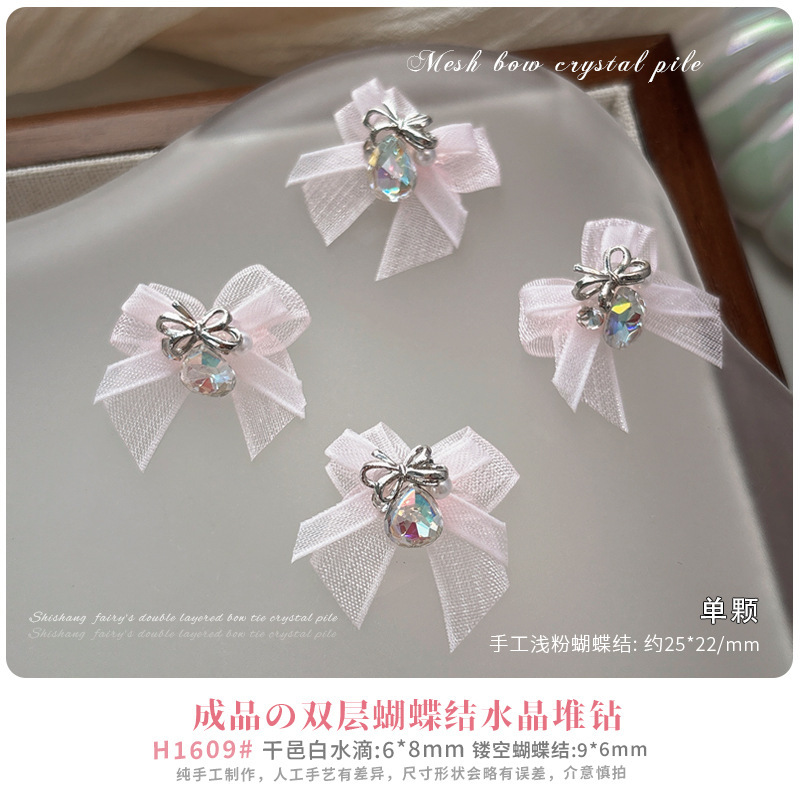 欧根紗の蝶結びの山のドリルのネイルアクセサリーの新型の純白のピンクの蝶結びの完成品の大きいダイヤモンドのネットの赤い爆発金|undefined