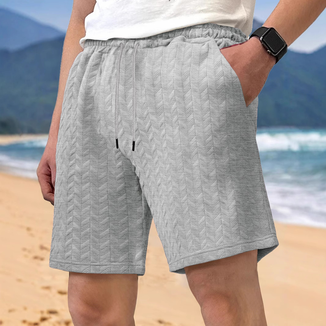 Europa y Estados Unidos ropa de hombre transfronteriza spot verano suelta pantalones cortos de color sólido jacquard correa de hombre casual pantalones cortos de playa