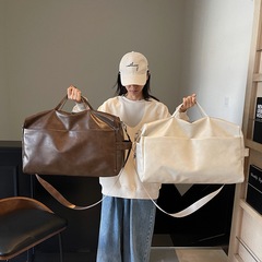 大容量短距離旅行バッグ女性2025新型PUシンプル運動フィットネスバッグ高級感純色バッグ