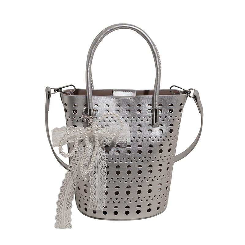 Bolso de cubo de diseño de nicho 2025 nuevo bolso de hombro con agujero hueco bolso de mensajero con lazo de estilo occidental mujer