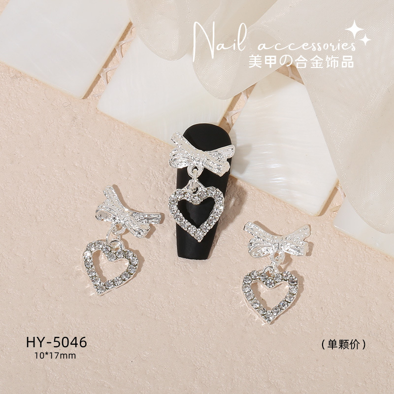 Nuevo arco de uñas amor aleación decoración de uñas flor de la luna mariposa clavo taladro fábrica joyería al por mayor