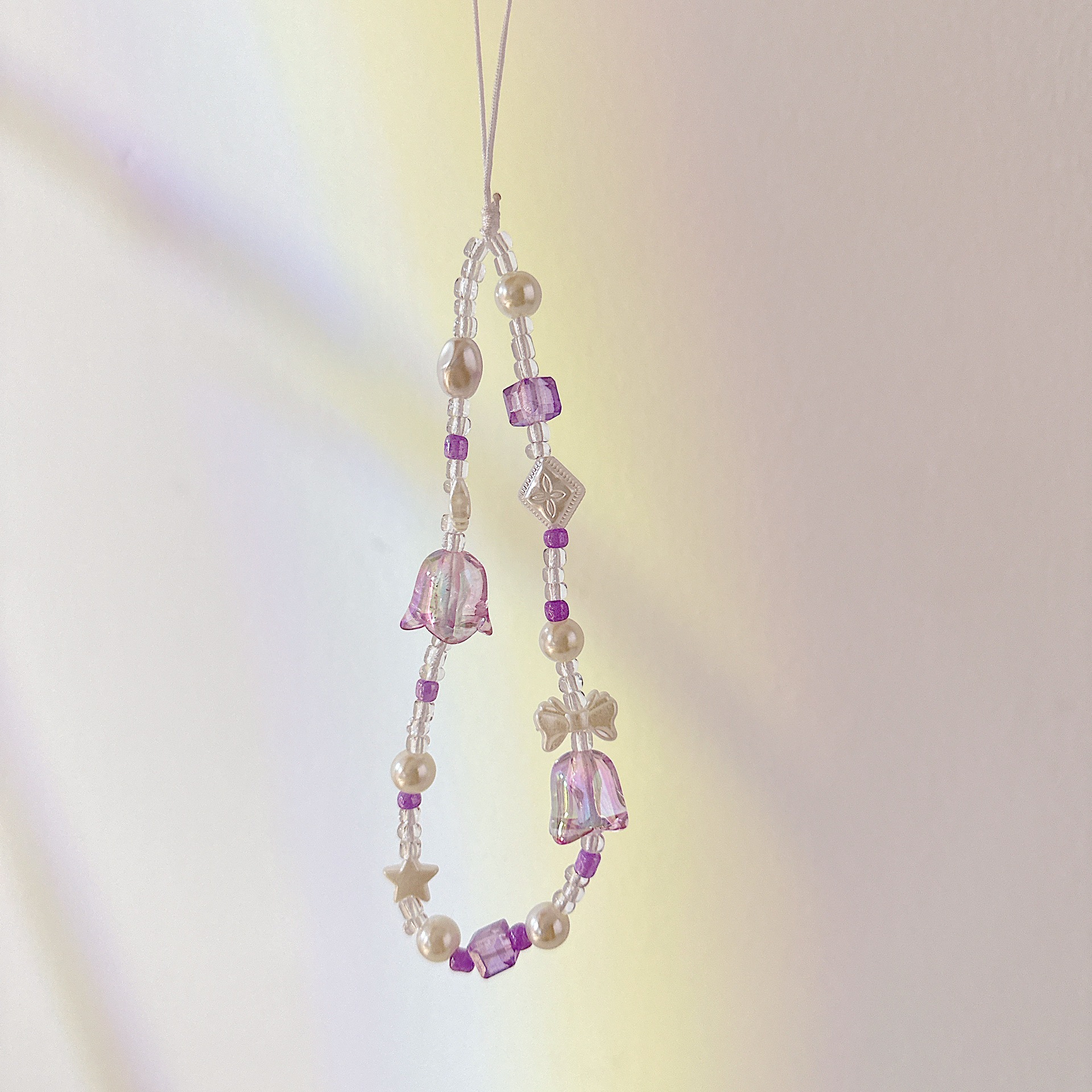 Aplicable cadena coreana orquídea de campana cadena de muñeca arco cuentas de caso de teléfono móvil colgante anti-perdida colgar pulsera trenzada