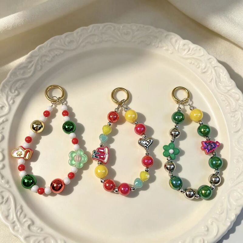 Christmas-themed color-blocking bead phone chain with Christmas tree and flower pendants, handmade keychain and bag accessory Christmas-themed color-blocking bead phone chain with Christmas tree and flower pendants, handmade keychain and bag accessory