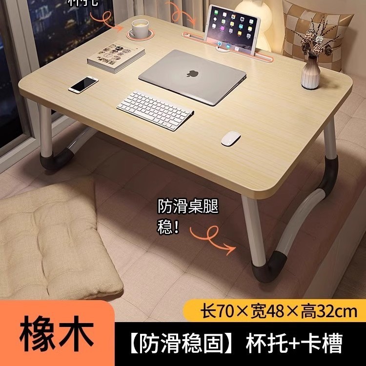折り畳み可能なベッドの上の小さなテーブルは机のノートパソコンのテーブルを勉強します。|undefined