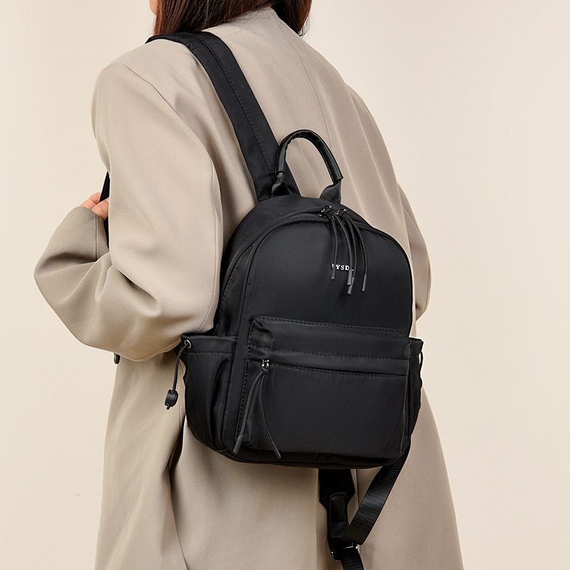 2025 nueva mochila de viaje simple de color sólido mochila de mujer casual letras extranjeras mochila de gran capacidad