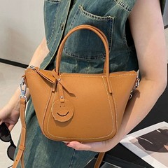 トップ層牛革シングル肩女性バッグ大容量斜め掛け女性笑顔ジッパーファッションシンプルなショッピングバッグ多仕切り