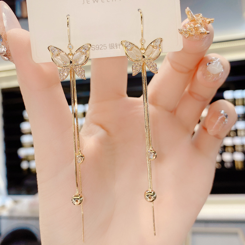 S925 aguja de plata Corea del Sur Dongdaemun elegante micro con incrustaciones de circón mariposa borla anti-perdida hilo de oreja moda pendientes del todo-fósforo para las mujeres