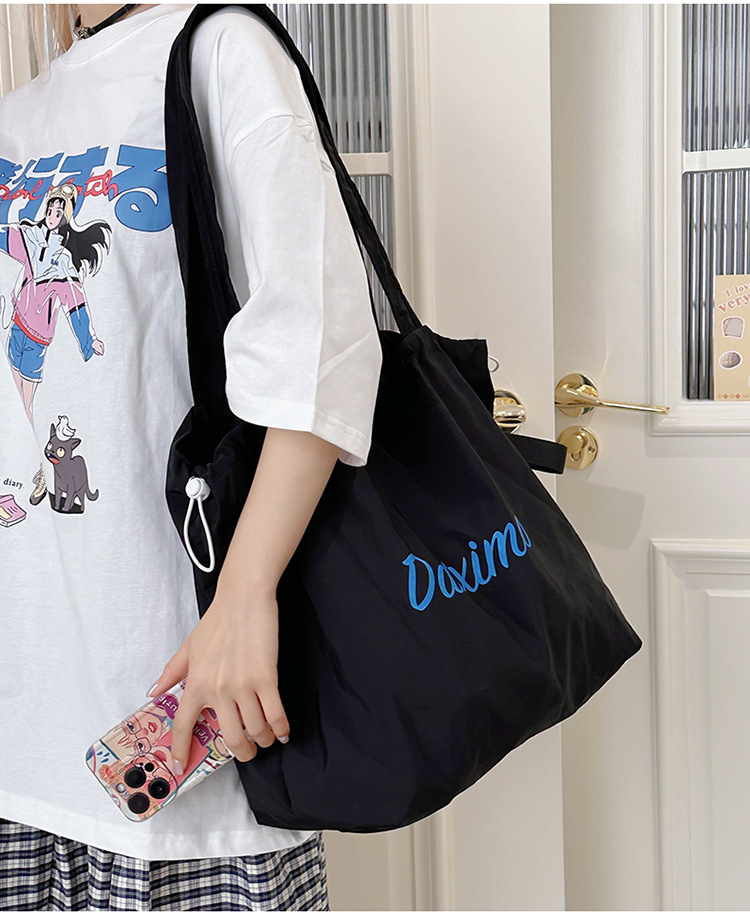 Solid color large-capacity tote bag 2025 bestseller, fashionable commuting lightweight handbag, laid-back style drawstring nylon bag for women undefined