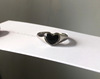 Retro brand design fashionable black ring heart shaped, on index finger