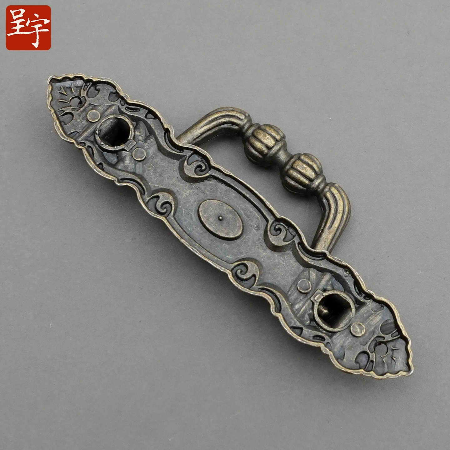 Antique‑style metal drawer handle, decorative bronze/golden finishes, multiple motifs
