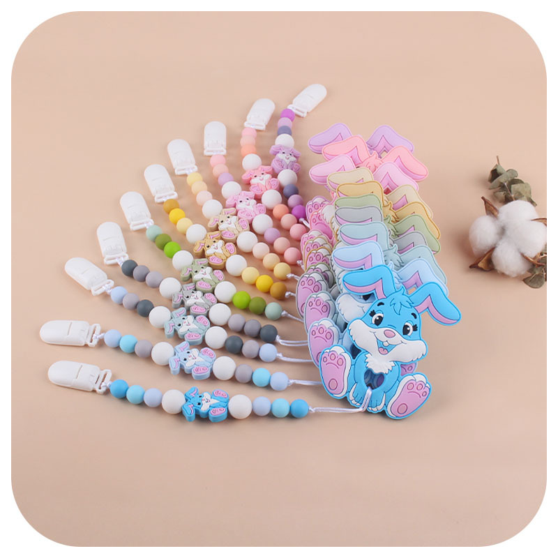Amazon nuevo bebé suministros de dibujos animados conejo de silicona juguete mordedor pezón anti-gota cadena molar traje