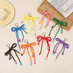 新しい色の手編みの蝶結びのキーホルダーは学生のカバンのかわいいカップルのリュックサックを掛けて卸売りを飾ります。