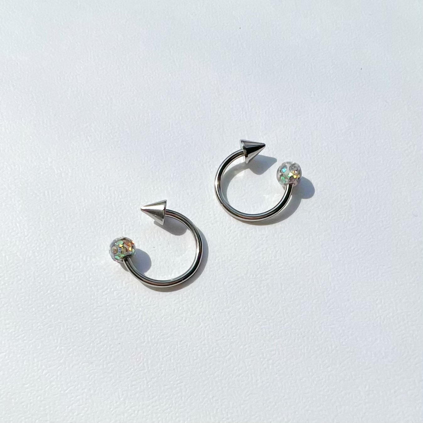 Silver pointed spike labret stud material detail