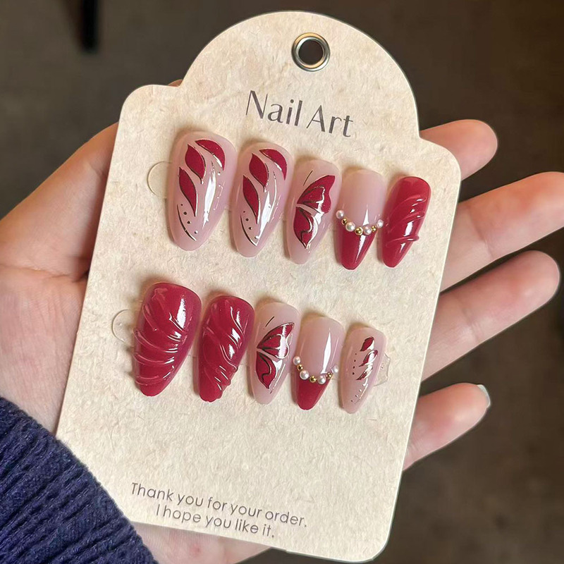 Festive Holiday Nail Art with Gold Stamping, Pearl Butterfly Wings, Wearable Nails, Beautiful Red Nail Pieces, Removable Fake Nails Festive Holiday Nail Art with Gold Stamping, Pearl Butterfly Wings, Wearable Nails, Beautiful Red Nail Pieces, Removable Fake Nails