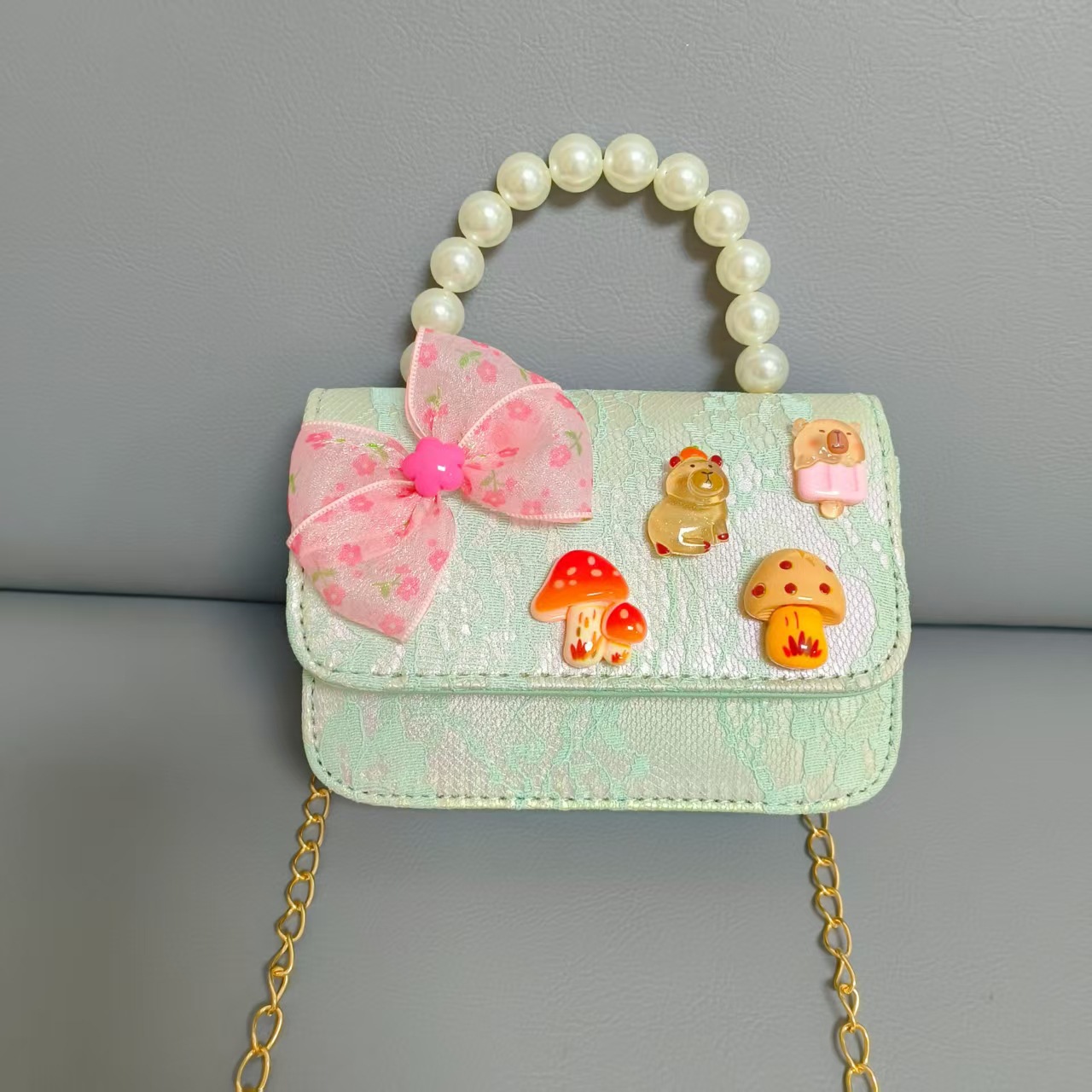 Bolsos para niños nuevos bolsos de perlas de arco para niñas bolsos de cinturón de estilo de fragancia bolsos de cadena bolsos de cambio bolsos