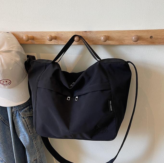Bolso tote de lona de gran capacidad explosivo transfronterizo 2025 nuevo estilo de clase bolso de mensajero de ocio bolso de viaje femenino